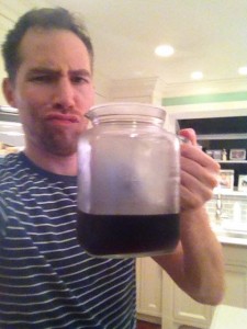 tate holding cold brew coffee